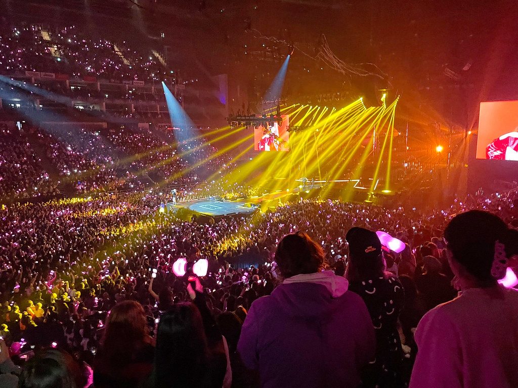 K-pop concert crowd with lightsticks