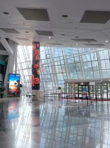 n illuminated digital media column in the spacious lobby of G-Tower