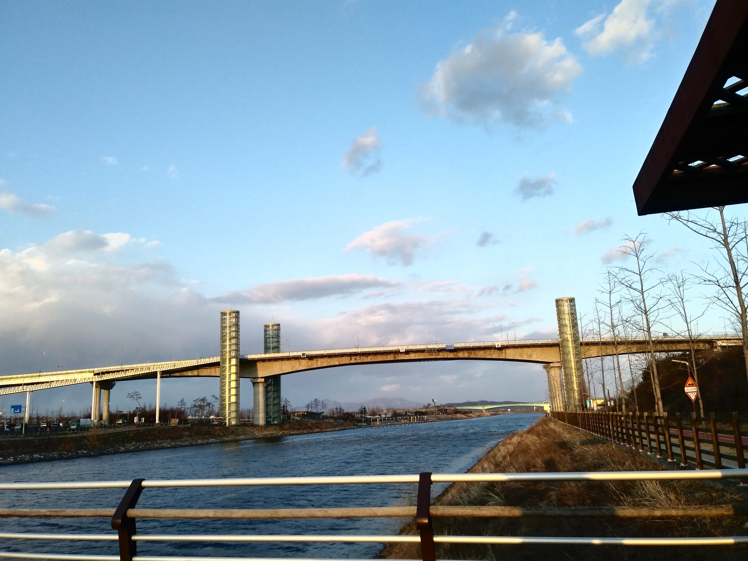 Gyeyang Bridge arching over the Ara Waterway canal under a blue sky in Incheon
