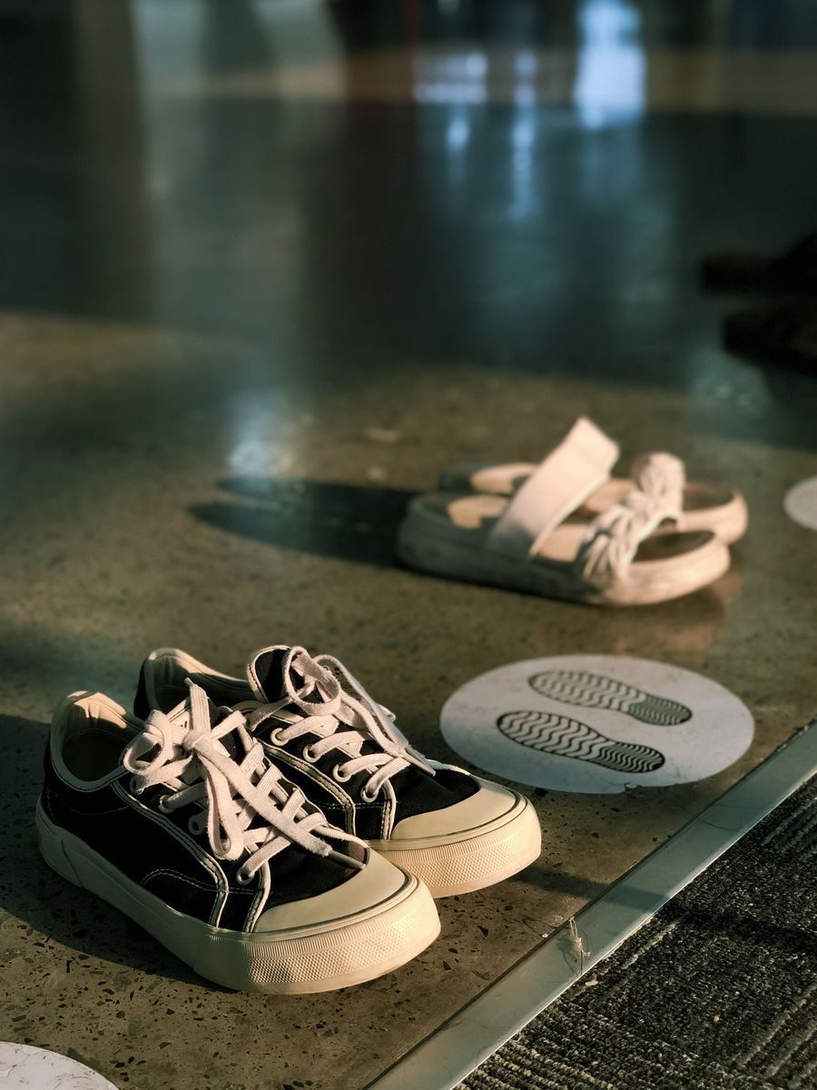 Shoes lined up neatly beside a doorway