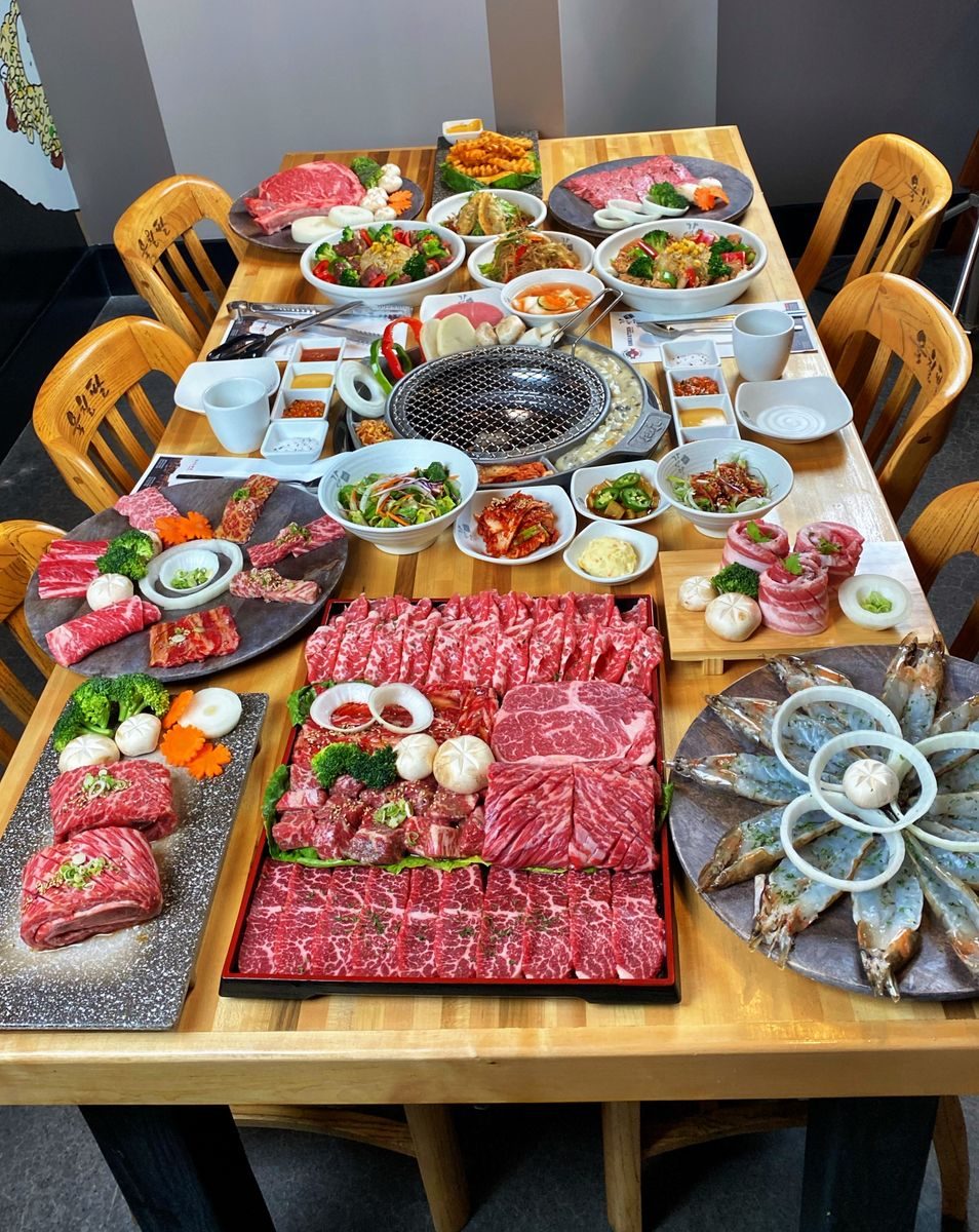 A table set with multiple small dishes and shared plates
