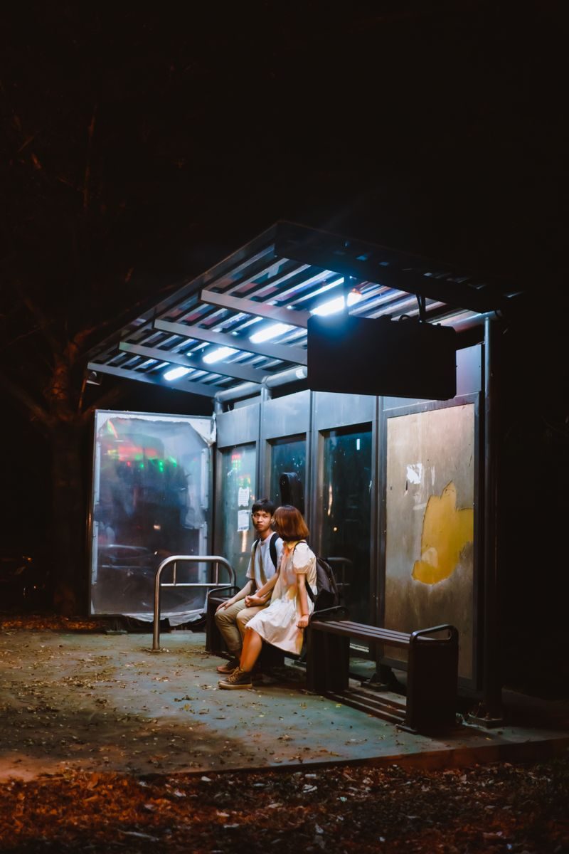 Male and female students sheltering from the rain