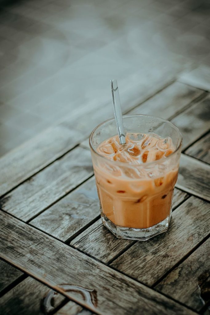 Tall glass of iced coffee with condensation on the outside