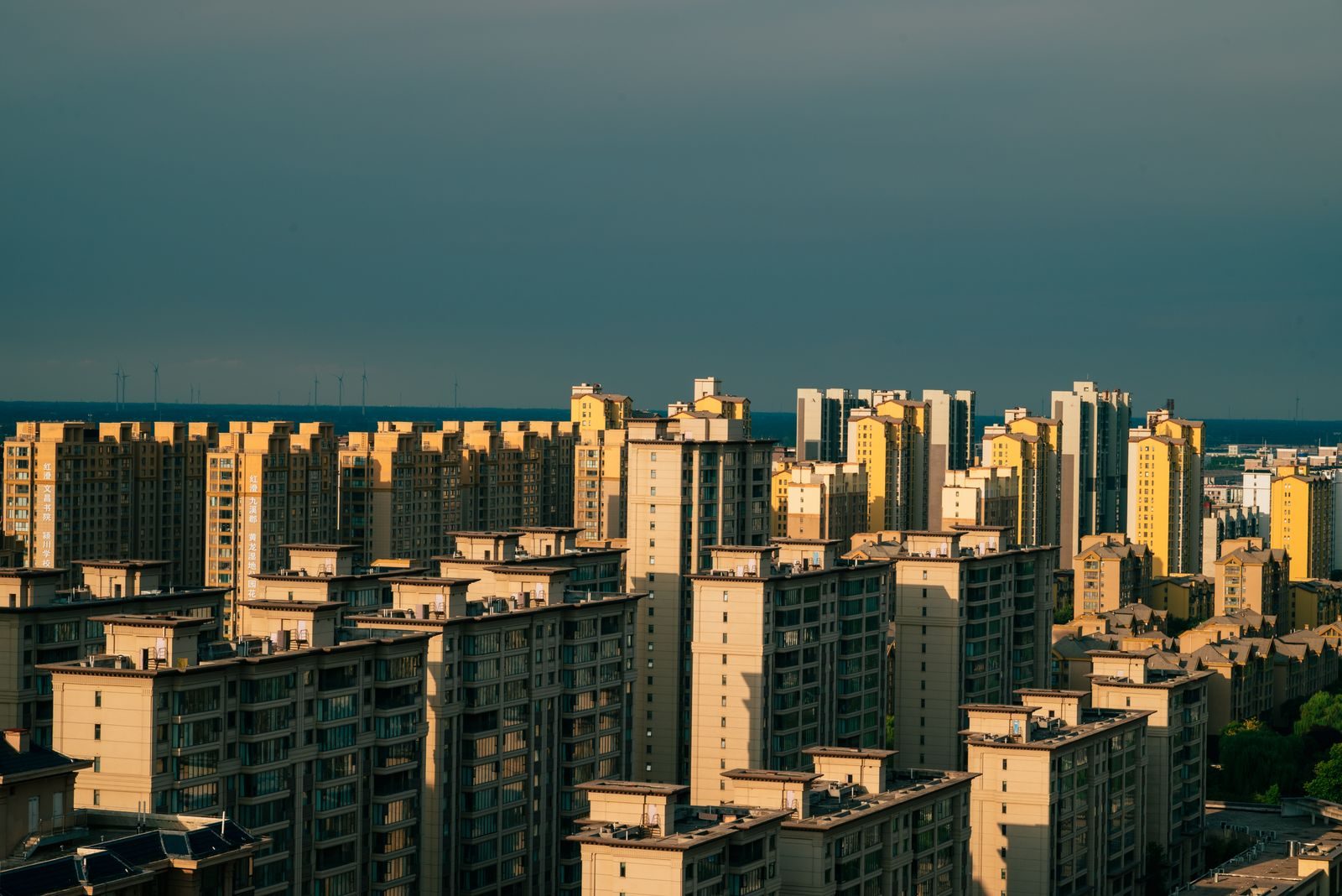 Rows of identical high-rise residential towers seen from below