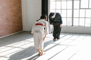 Two people greeting each other with a slight bow