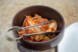 Fermented cabbage in a bowl with red seasoning