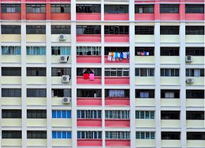 An enclosed balcony with laundry hanging to dry