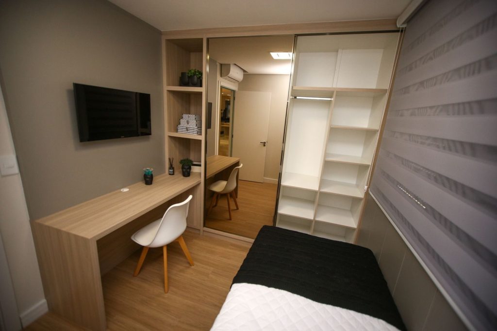 A compact single room with minimal furniture