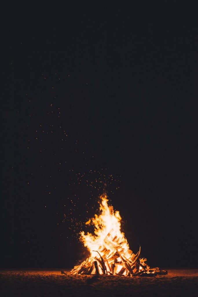 A large cone-shaped straw bonfire burning at a Daeboreum festival