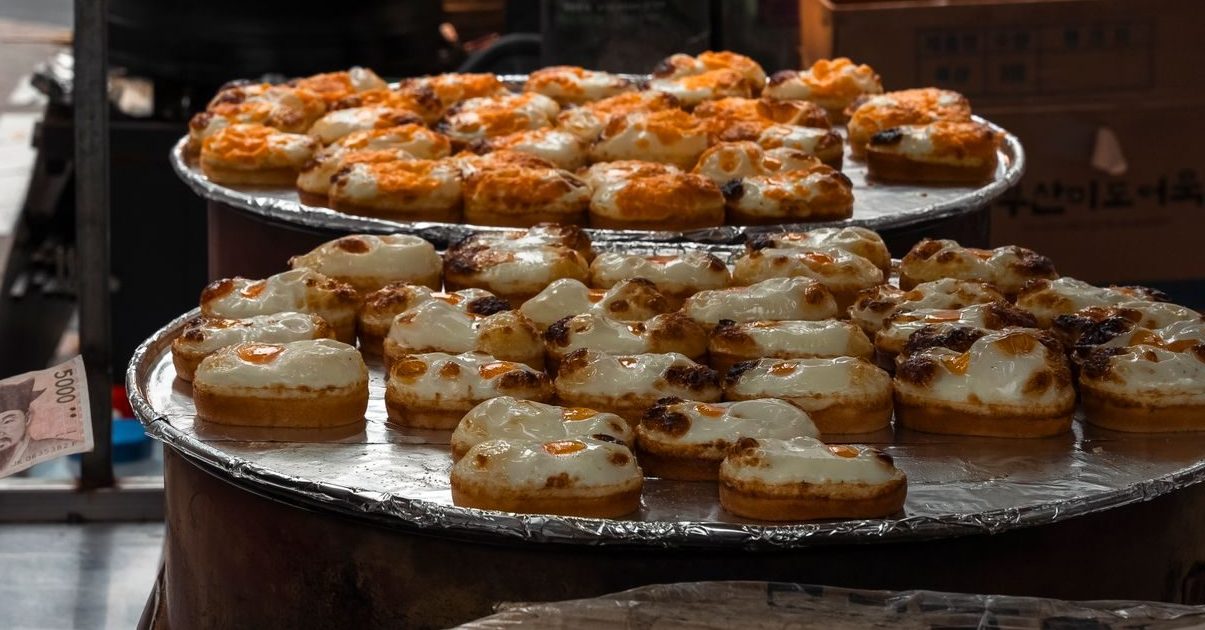 Golden oblong Korean egg bread with a whole egg baked into the top
