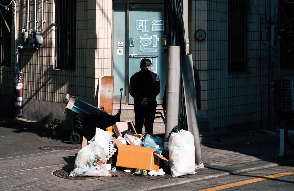 Urban street scene in Seoul featuring a person and street elements on a sunny day.
