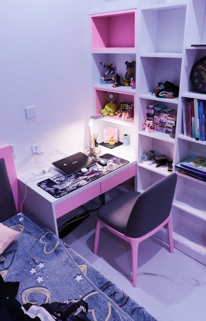 A small single room with a bed and desk against the wall