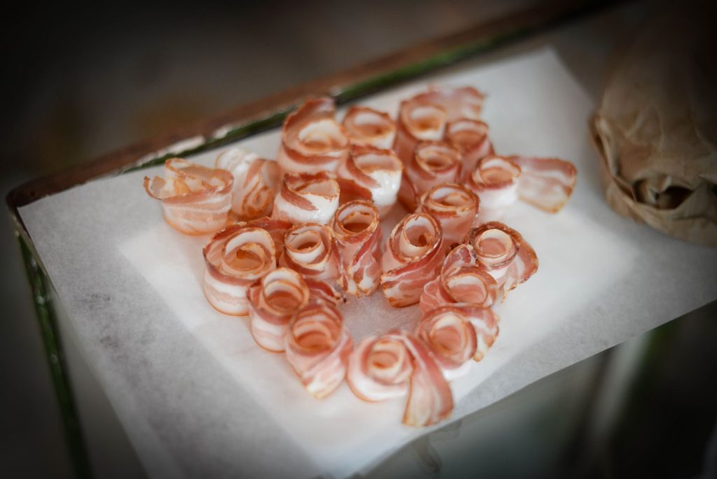 Thinly sliced raw pork belly arranged on a plate