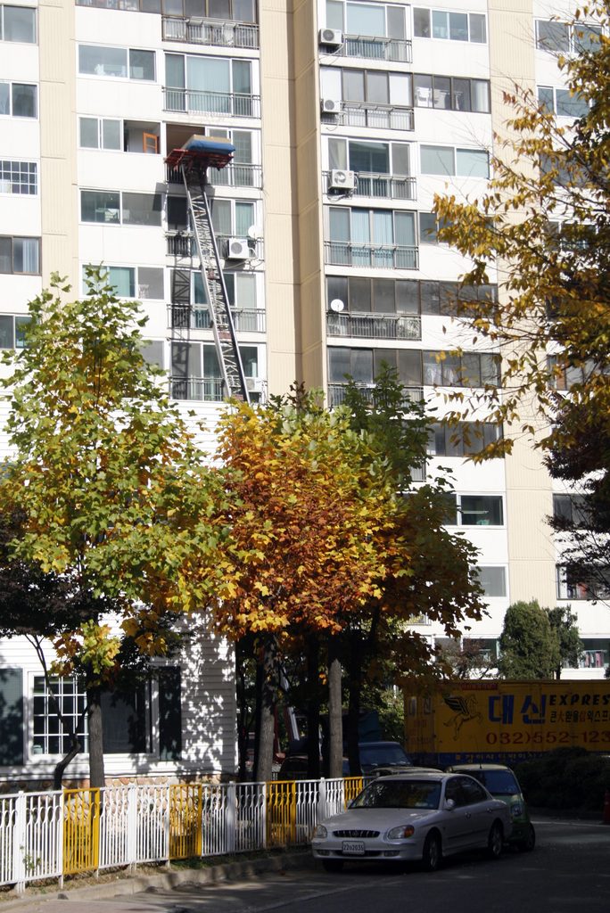Moving goods are being lifted using a Korean ladder truck.
