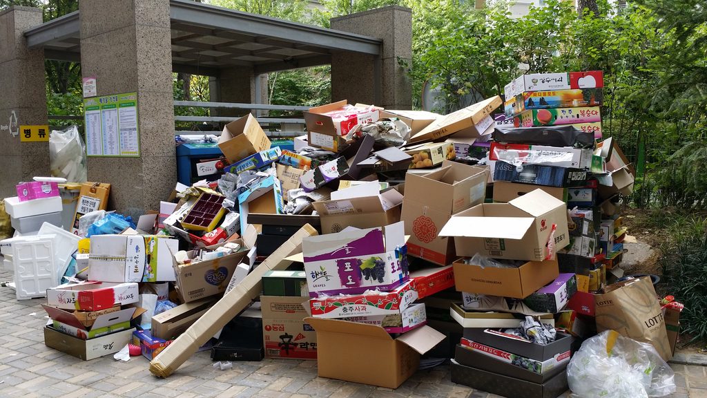 Piles of cardboard boxes for recycling are stacked up at a waste sorting area in Korea.