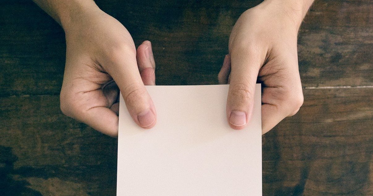 person holding white printer paper