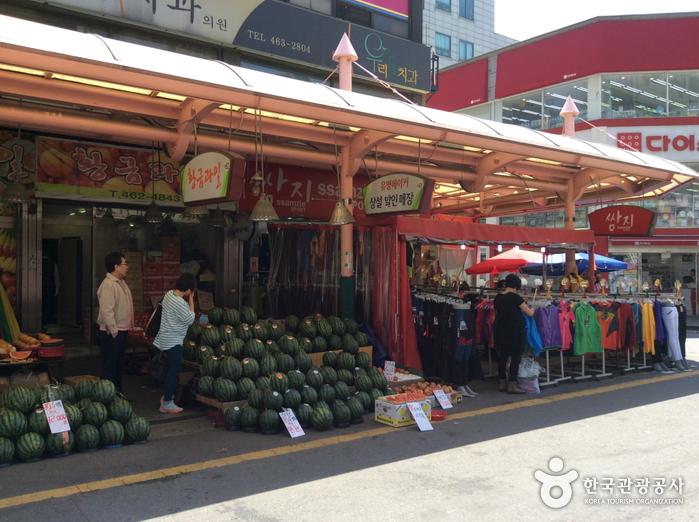 Piles of watermelons and fruit boxes for sale in front of a shop at Moraenae Market