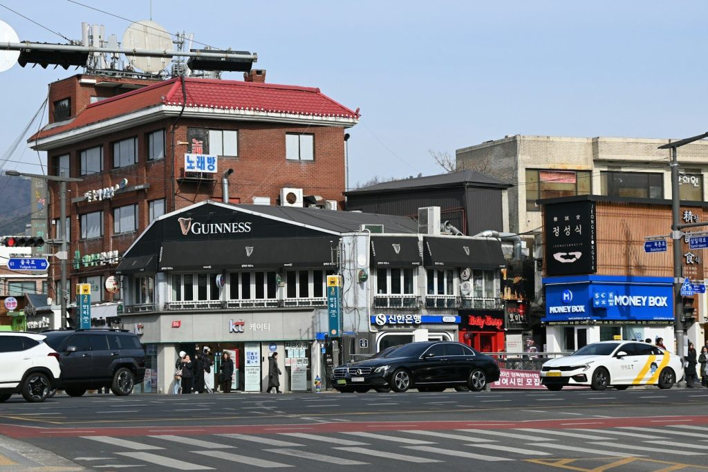 Street view of buildings and cars on a sunny day